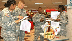 soldiers giving out Informational Packets and Condoms to promote awareness and education about HIV and AIDS for World AIDS Day.