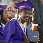 African American woman in purple graduation gown