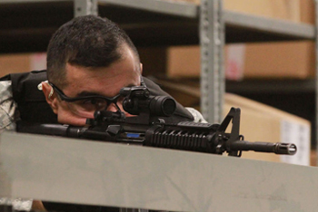 Spc. Pablo Godinez provides overwatch as a marksman during a multi-incident training exercise scenario.