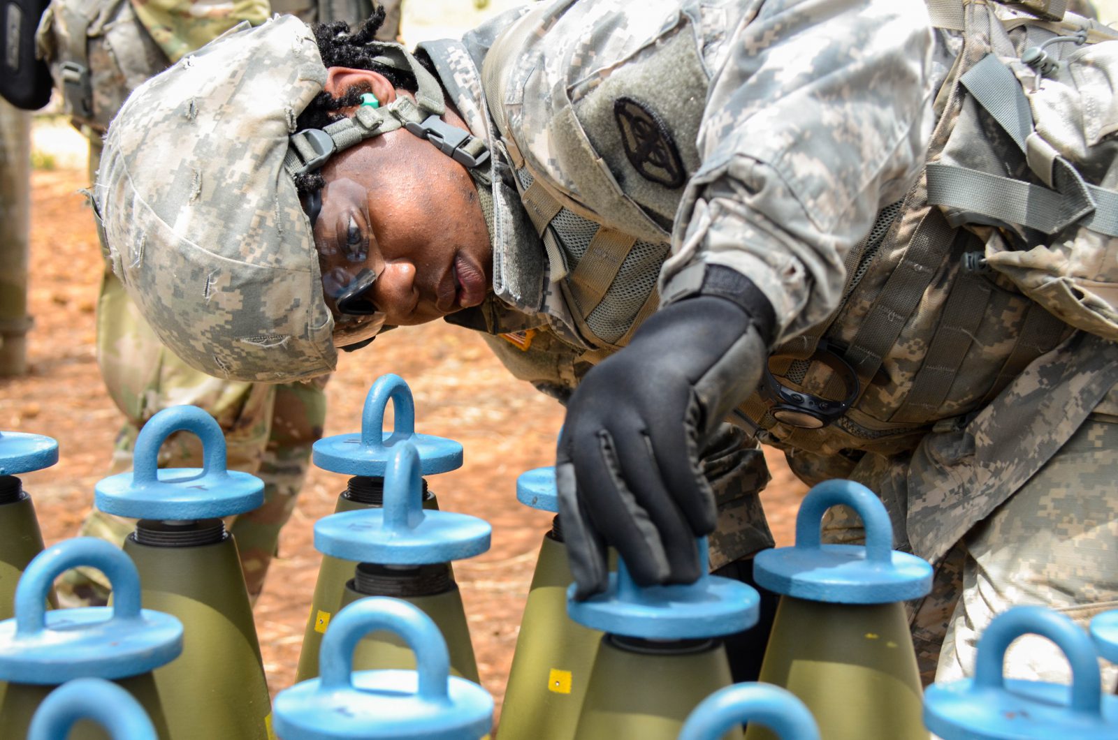 Pvt. Nareisha George prepares an ammunition round for a fuse during live-fire training in May at Fort Sill, Oklahoma. (Photo by Meghan Portillo / NCO Journal)