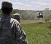 Soldiers watch helicopter land