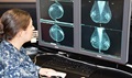 Navy Lt. Cmdr. Denise Thigpen, director, Breast Imaging Center at the Murtha Cancer Center at Walter Reed Bethesda, reads two mammograms of a patient. (Courtesy photo)