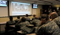Soldiers from the 399th Combat Support Hospital, 804th Medical Brigade, 3d Medical Command (Deployment Support) watch video footage of their performance during an exercise held April 2, 2016 at the Mayo Clinic Multidisciplinary Simulation Center in Rochester, Minnesota. The unit's every move was recorded at the facility, which allowed them to review and improve their performance throughout the course of the exercise. During the exercise, the unit, which is based out of Fort Devens, Massachusetts, practiced the Team Strategies and Tools for Enhanced Performance and Patient Safety, or TeamSTEPPS, model of patient care. TeamSTEPPS is a framework implemented by the Department of Defense to optimize performance of military medical teams and reduce communication errors that can result in improper patient care. (Photo by: Staff Sgt. Andrea Merritt)