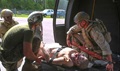 Sailors from 2nd Medical Battalion, 2nd Marine Logistics Group, and Coast Guardsmen evacuate a simulated casualty during a Tactical Combat Casualty Care course. 