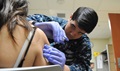 Navy Petty Officer 2nd Class Sterling Wold, a hospital corpsman in Naval Hospital Camp Pendleton's Family Medicine Immunizations Clinic, gives a shot to a patient. Extensive safety testing for this potential norovirus vaccine has been performed in civilian populations, but because the recruit training population regularly experiences large outbreaks of norovirus, it is a perfect place to test the effectiveness of the vaccine for the military. (U.S. Navy photo by Hospital Corpsman 2nd Class Markian R. Carreon)