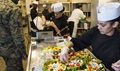 U.S. Marine Corps Cpl. Gabriela Justice, a food service specialist with Mess Hall WC-100, Headquarters Battallion, 2nd Marine Division, prepares a fruit dish. 