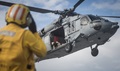 Navy Boatswain's Mate 2nd Class John Davis, signals an MH-60S assigned to the Blackjacks of Helicopter Sea Combat Squadron (HSC) 21 aboard hospital ship USNS Mercy. 