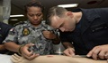 Royal Australian Navy Able Seaman Mele Buadromo (left), from Melbourne, Australia, and Hospitalman Elijah Boyd, from Mount Zion, Ill., participate in a suturing class aboard the hospital ship USNS Mercy. 