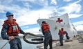 Sailors assigned to Joint Base Pearl Harbor-Hickam handle line as the hospital ship USNS Mercy moors at JBPHH. Mercy is deployed in support of Pacific Partnership 2016. 