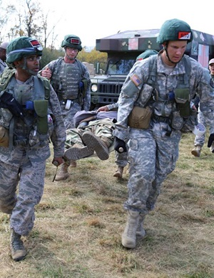 During a field exercise, Operation Bushmaster, fourth-year medical students from the Uniformed Services University of the Health Sciences were constantly faced with unfolding scenarios. While triaging the wounded, they prepared for their evacuation and care in flight. (DoD photo by Sharon Holland)