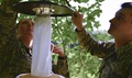 U.S. Air Force Airman 1st Class Samantha Nice, left, and Airman 1st Class Jess Hixson, put up a mosquito net as part of vector surveillance. Nice and Hixson are taking part in an exercise working with state and local emergency management agencies and first responders. (U.S. Air Force photo by Tech. Sgt. Amy M. Lovgren)