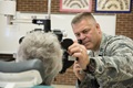 U.S. Air Force Capt. Brett Ringger, optometrist , 136th Medical Group, Texas Air National Guard, examines a patient  during the Greater Chenango Cares Innovative Readiness Training in Cortland, New York. The IRT provided medical care to patients at no cost, as well as eye examinations and glasses on site. (U.S. Air Force photo by Senior Master Sgt. Elizabeth Gilbert)