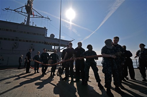 MEDITERRANEAN SEA  - Sailors assigned to the amphibious command ship USS Mount Whitney (LCC 20) practice their fire-fighting techniques while underway. Mount Whitney, homeported in Gaeta, Italy, is the U.S. 6th Fleet flagship and operates with a combined crew of U.S. Sailors and MSC civil service mariners. The civil service mariners perform navigation, deck, engineering and supply service operations, while military personnel aboard support communications, weapons systems and security. 