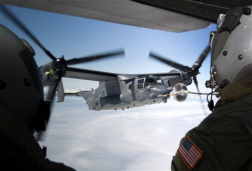 A CV-22B Osprey receives fuel June 21, 2013, off the coast of Greenland by a 7th Special Operations Squadron MC-130H Combat Talon II.