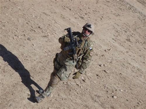 Rod Matthews, chief of Future Operations at the Joint Multinational Training Command in Grafenwoehr, Germany, walks alongside a vehicle while working as a civilian augmentee in Zabul Province, Afghanistan earlier this year. Matthews, a Department of the Army Civilian employee, was a civilian tactical exploitation specialist assigned to a Navy Explosive Ordinance (EOD) team. (Photo by Denver Makle, Joint Multinational Training Command Public Affairs)