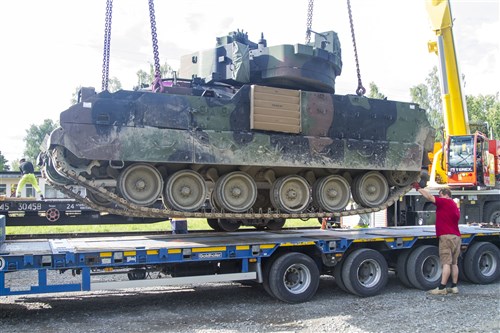 Latvian civilian contractors guide an M2A2 Bradley Fighting Vehicle (BFV) onto a trailer at the rail yard in Garkalnes, Latvia on July 9, 2016. Latvian contractors are working with soldiers from the 386th Transportation Detachment, 39th Transport Battalion to provide movement control for 3rd Battalion, 69th Armored Regiment whose soldiers are training with their Latvian allies in support of Operation Atlantic Resolve which is being conducted in Eastern Europe to demonstrate U.S. commitment to the collective security of NATO and dedication to enduring peace and stability in the region.