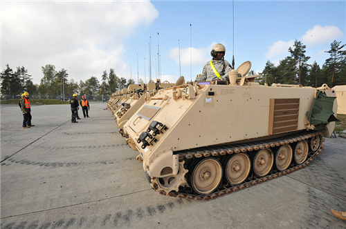 Soldiers from the 1st Brigade Combat Team, 1st Cavalry Division, prepare equipment during Exercise Combined Resolve III at Grafenwoehr, Germany, Oct. 6. The equipment is part of the European Activity Set), a battalion-sized set of equipment pre-positioned on the Grafenwoehr Training Area to outfit and support U.S. Army forces rotating to Europe for training and contingency missions. The 1st Cav currently serves as the Army's Regionally Aligned Force in support of the U.S. European Command. Combined Resolve III is a U.S. Army Europe-led, multinational exercise at the Joint Multinational Training Command's Hohenfels and Grafenwoehr Training Areas focused on maintaining and enhancing interoperability during unified land operations in a decisive action training environment. (Photo by Gertrud Zach) 