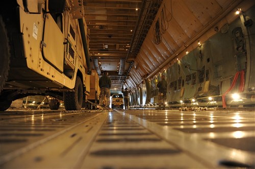U.S. Air Force personnel load a medium tactical vehicle from U.S. Army Europe's 10th Army Air and Missile Defense Command onto a C-5 Galaxy transport plane at Ramstein Air Base, Germany, Jan. 8. The load-up was part of the 10th AAMDC's deployment to Turkey, along with other USAREUR, Army and multinational forces, in support of NATO operations.