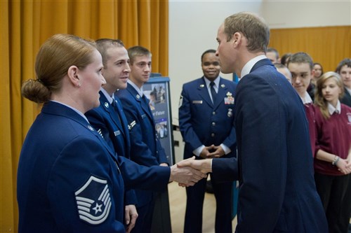 CAMBRIDGE, United Kingdom -- Tech. Sgt. Daniel Baker, 423rd Security Forces Squadron, shakes hands with the Duke of Cambridge during his visit to The Manor School. Five Airmen from the 423rd SFS spoke with Prince William about the mentoring program they’ve established through their honorary commander, Julie Spence, the former Chief Constable of Cambridgeshire.