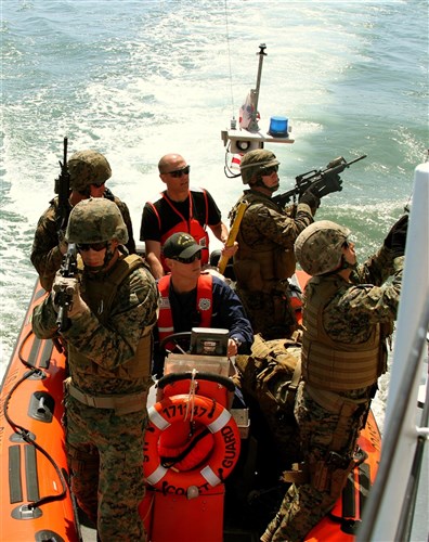 Camp Pendleton, Calif.-Marines, attached to Black Sea Rotational Force-11, and Coast Guardsmen attached to U.S. Coast Guard Cutter Sea Otter, San Diego, Calif., hook a ladder to board the patrol boat, as part of their Visit, Boarding, Search and Seizure training. The VBSS training will help enhance the skills of Marines attached to the Ground Combat Element of BSRF-11, which is a Special Purpose Marine Air-Ground Task Force that will be performing security cooperation activities with foreign militaries in the Black Sea, Balkan and Caucasus region. Cpl. Tatum Vayavananda, 3/2/2011 