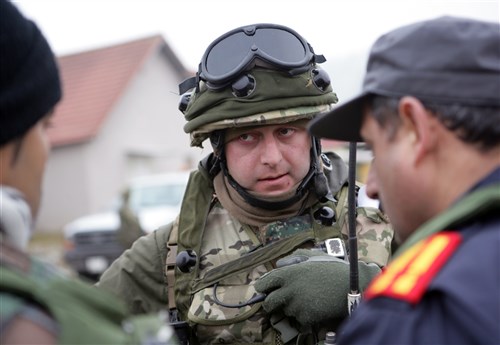 HOHENFELS, Germany, (Feb. 20, 2011) -A Georgian soldier assigned to the 33rd Light Infantry Battalion talks to an exercise role-player during a training patrol at the Joint Multinational Training Center, here. The soldier is participating in the Georgia Deployment Program- Mission Readiness Exercise, where a majority of the Marines serving as observer/controllers were from 3rd Bn, 7th Marine Regiment, mentoring the 33rd LIB before they head to Afghanistan this spring.