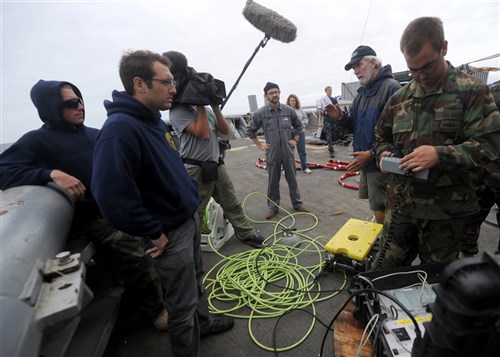 NORTH SEA (July 26, 2011) Mr. Charlie Baker (second from right), a civilian who works with the Mobile Diving and Salvage Unit (MDSU) 2 area search platoon, discusses the search parameters of the next mission with Navy archeologist Alexis Catsambis aboard the Military Sealift Command rescue and salvage ship USNS Grasp (T-ARS 51). MDSU-2 and Navy archeologists, scientists, and historians are in the North Sea conducting diving operations verifying the sites of suspected shipwrecks. The researchers hope to find USS Bonhomme Richard, the historic ship commanded by John Paul Jones.  (U.S. Navy Photo by Mass Communication Specialist 1st Class Ja&#39;lon A. Rhinehart/RELEASED)