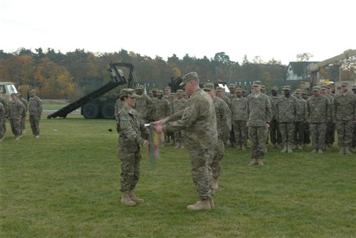 Capt. Margaret Marcello, the commander of the 515th Transportation Company, 391st Combat Sustainment Support Battalion, 16th Sust. Brigade, and 1st Sgt. Christopher Gilbreath, the first sergeant of the 515th Trans. Co., prepare to case the guidon during the ceremony Nov. 4 at Griffin Field, Mannheim, Germany in preparation for the unit's upcoming deployment in support of Operation Enduring Freedom.