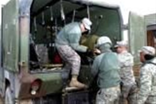 Spc. Khristoffer Sandoval, Cabo Rojo, Puerto Rico, infantryman, A Company, 1st Battalion, 296th Infantry, Multinational Battle Group East, and a member of the Puerto Rico National Guard, helps load an injured person into the back of an M998 Humvee Ambulance Jan. 7 outside of Ferizaj/Urosevac. Sandoval, a member of the Puerto Rico National Guard, was part of a Quick Reaction Force Validation Exercise. (U.S. Army photo by Pfc. Brian J. Holloran, 130th Public Affairs Detachment, Connecticut National Guard)