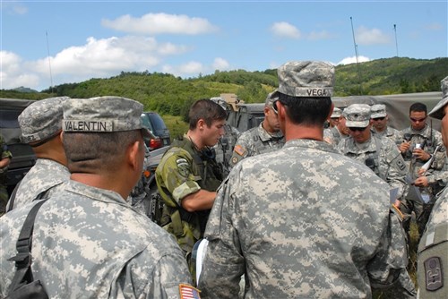 ORLLAN/ORLANE, Kosovo &mdash; Swedish army 1st Lt. Christopher Johannson, Stockholm, Sweden, gives an orientation briefing to train Alpha Company, 1st Battalion, 296th Infantry Regiment soldiers near a starting point for Administrative Boundary Line patrols with Serbian Armed Forces Aug 9. The briefing was ongoing as the soldiers asked questions and shared experiences during the event.  The U.S. infantrymen are members of the Puerto Rico Army National Guard and are deployed to Kosovo for the NATO Kosovo Force 13 rotation.   (U.S. Army photo by Sgt. Joshua Dodds)