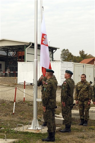 Soldiers from Polish COY, Multinational Battle Group East, render salutes as the Polish flag is raised during a Transfer of Authority ceremony at Camp Nothing Hill in Leposavic/Leposaviq, Kosovo, Oct. 11. The Polish COY recently took over responsibility of Quick Reaction Force, patrolling and guard duties at Gate 1 along the Administrative Boundary Line with Serbia. Before the Poles, Greek soldiers from Multinational Battle Group North were in charge of these duties at Nothing Hill. (U.S. Army photo by Sgt. Jerry Boffen, 130th Public Affairs Detachment, Connecticut National Guard.)