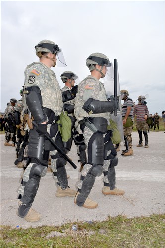 Soldiers from Company C, 1st Squadron, 38th Cavalry Regiment prepare to block a group of demonstrators during the annual Silver Saber training exercise at Camp Vrelo, Kosovo, Oct. 16, 2013. Soldiers from the 525th Battlefield Surveillance Brigade are part of KFOR’s Multinational Battle Group-East: a multinational task force made up of soldiers from nine different countries as well as National Guardsmen from five states. 