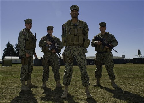 GRAFENWOEHR, Germany - Master-At-Arms 2nd Class Jacob Cook, Master-At-Arms 3rd Class Kyle Gipe, Master-At-Arms 2nd Class Triston Jointer and Master-At-Arms 2nd Class Patrick Long provide security for Camp Aachen, during Combined Endeavor (CE) 2012, Joint Multinational Training Command, Grafenwoehr, Germany, Sept. 7, 2012. All personnel are master at arms from the Maritime Expeditionary Security Squadron 3, San Diego, Calif. CE12 is a multinational command, control, communications and computer systems exercise designed to build and enhance communications and network interoperability between 41 nations and international organizations.