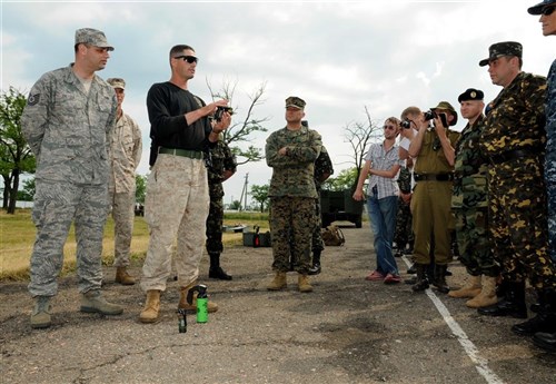 SHIROKILAN, Ukraine (June 11, 2011) - U.S. Marine Staff Sgt. Daniel Botty, a non-lethal weapons instructor, explains the proper use of non-lethal weapons during a media availability as part of exercise Sea Breeze 2011. Air, land and naval forces from Azerbaijan, Algeria, Belgium, Denmark, Georgia, Germany, Macedonia, Moldova, Sweden, Turkey, Ukraine, the United Kingdom and the United States are participating in Sea Breeze, the largest multinational maritime exercise this year in the Black Sea, June 6-18, and is co-hosted by the Ukrainian and U.S. Navies. (U.S. Navy photo by Mass Communication Specialist 3rd Class Caitlin Conroy/RELEASED)