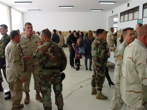 Soldiers and their families partake in the post-ceremony reception.