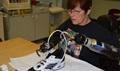 Donna Lowery works to put a shoe lace through the eyelet of a tennis shoe as part of her occupational therapy at the Center for the Intrepid at Joint Base San Antonio, Fort Sam Houston, Texas. U.S. Army photo by Lori Newman  