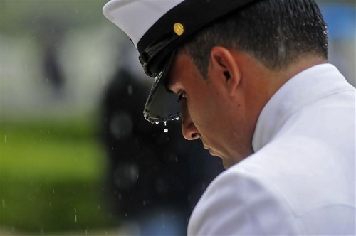 NETTUNO, Italy (May 28, 2012) - Chief Operations Specialist Jose Ramiro bows for a moment of silence during the Memorial Day ceremony at Sicily-Rome American Cemetery. During the ceremony, multinational veterans, service members, students and families gathered to honor and pay tribute to the fallen warriors who gave their lives during the liberation of Italy in 1943.  