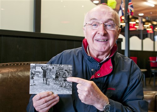 Yeves Tariel points to a picture of him as a young boy playing Nazis and the French Resistance in Lisieux, France, just before his town was bombed by U.S. planes during World War II.
