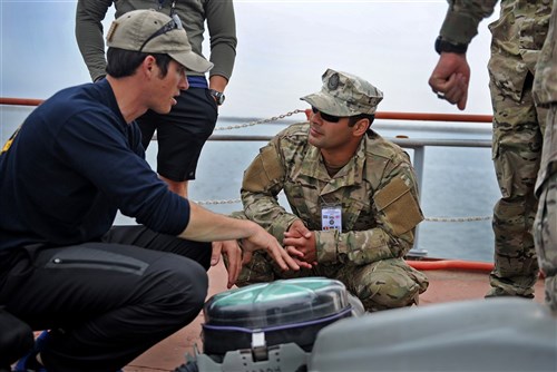 CONSTANTA, Romania (May 31, 2012) - Explosive Ordnance Disposal Technician 1st Class Nick Tabacco, left, assigned to Explosive Ordnance Disposal Mobile Unit (EODMU) 8, explains the MK-16 Mod 1 underwater breathing apparatus’ basic functions to Azerbaijani navy Explosive Ordnance Disposal Technician 3rd Class Beybala Maharramov, center, aboard the Romanian navy ship Saturn during Eurasian Partnership (EP) Dive 2012. EP Dive 2012, a multinational training event co-hosted by the Romanian and U.S. Navies, includes participants from Azerbaijan, Bulgaria, Georgia, Romania, Ukraine and U.S.