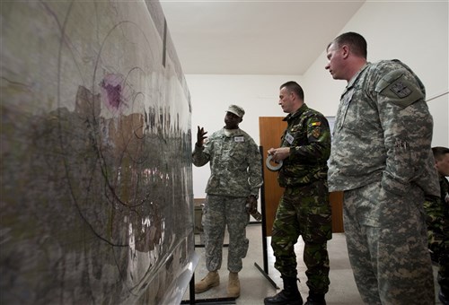 U.S. and partner nation soldiers review exercise information as part of Saber Guardian 2013, a U.S. is a European Command Black Sea regional exercise planned and executed by the Romanian Land Forces and U.S. Army Europe.  This is the first time these Black Sea regional countries (Romania, Bulgaria, Armenia, Azerbaijan, Republic of Georgia, Moldova, and Ukraine) have come together to train and exercise their battlestaff and command post procedures at one location.  Serbian and Polish Land Forces are also participating to enhance their relationships with these Black Sea countries.  There are more than 150 training audience members, support staff and contractors supporting the training at the Romanian Land Forces Combat Training Center in Cincu, Romania from 15-25 April. 