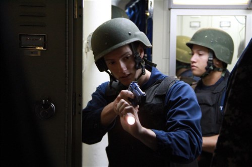 MEDITERRANEAN SEA  - Electronics Technician 2nd Class Michael Phillips, left, and Quartermaster Seaman Michael Pagan, right, conduct a simulated search during an anti-terrorism force protection drill aboard the guided-missile frigate USS Robert G. Bradley (FFG 49). Robert G. Bradley, homeported in Mayport, Fla., is deployed conducting
maritime security operations and theater security cooperation efforts in the U.S. 6th Fleet area of responsibility 