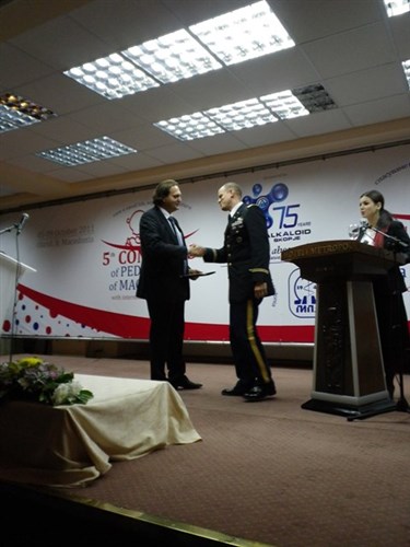 LTC Michael Tarquinto, Chief of the Office of Defense Cooperation, accepts an award of behalf of the Embassy from Dr. Aleksandar Sajkovski, President of the Pediatricians’ Association of Macedonia.