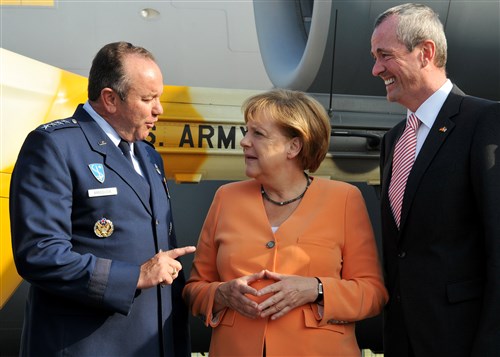 BERLIN - Chancellor Angela Merkel of Germany, greets Philip Murphy, U.S. ambassador to Germany, and Gen. Philip Breedlove, U.S. Air Forces in Europe and U.S. Air Forces Africa commander, during a tour of the U.S. military aircraft “corral” at the Berlin Air Show, commonly known as ILA 2012, here Sept 11. ILA 2012 is an international event hosted by Germany and more than 50 U.S. military personnel from bases in Europe and the U.S. are here to support the various U.S. military aircraft and equipment on display. The U.S. aircraft featured at ILA 2012 are the UH-60 Black Hawk, UH-72A Lakota, F-16C Fighting Falcon, C-17 Globemaster III, and C-130 Hercules.