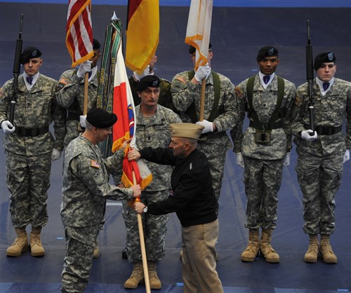 Adm. James Stavridis, commander of the U.S. European Command (in black jacket), passes the U.S. Army Europe flag to Lt. Gen. Donald M. Campbell Jr. during Campbell's assumption of command ceremony at Clay Kaserne in Wiesbaden, Germany, Jan. 9.