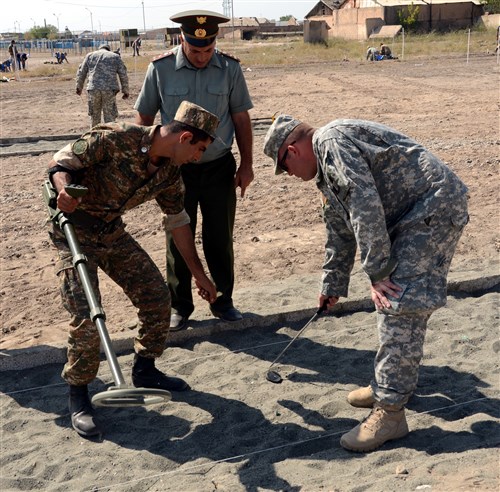 Sgt. 1st Class Jacob Nelson, a Wichita native with the Kansas National Guard, uncovers the simulated mine on a metal detector lane as part of a humanitarian demining action training course taught by soldiers of the Kansas National Guard and a civilian representative from the U.S. Humanitarian Demining Training Center. Kansas National Guardsmen and the HDTC representative are instructing Armenian peacekeepers and engineer battalions on international demining standards as part of the Humanitarian Mine Action program and will assist the Armenian government in developing a national standard operating procedure for demining.