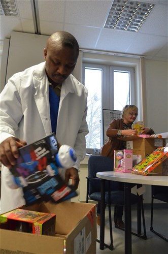 Lt. Col. Alex Eke, commander of the Katterbach Dental Clinic, and Marianne Teubner, Eke's office assistant, pack boxes full of toys to be delivered to Kinder-Jugend-Familienhilfe Ansbach Kastanienhof, a home for children of troubled families, Jan. 31.