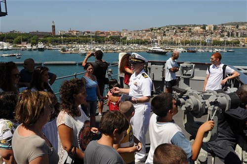 GAETA, Italy - Lt. Colin Dunlop, center, explains the ship’s capabilities to residents of Gaeta during a tour of the USS Mount Whitney (LCC 20). More than 800 of Gaeta’s residents toured the Mount Whitney’s quarterdeck, bridge, flight deck and medical facilities as part of community outreach efforts. Mount Whitney, homeported in Gaeta, Italy, is the U.S. 6th Fleet flagship and operates with a combined crew of U.S. Sailors and MSC civil service mariners. 