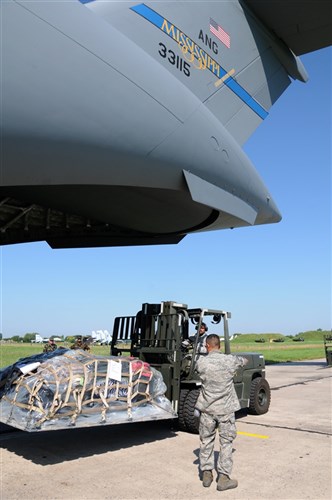 Senior Master Sgt. Art Cano and Tech. Sgt. Miguel Hernandez from the California Air National Guard unload a Mississippi Air National Guard C-17 at Mirgorord Air Base during SAFE SKIES 2011. The Air National Guard is in Ukraine supporting SAFE SKIES 2011, a 2-week multinational flying event preparing Ukraine and Poland to better protect their airspace during the 2012 EUROPCUP.   (U.S. Air Force Photo by Tech. Sgt. Charles Vaughn, 144 FW/PA / Released)