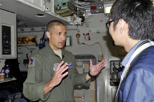 Airman 1st Class Oliver Vizitei, 3rd Airlift Squadron loadmaster, explains how much cargo can fit inside a C-17 Globemaster III to a visitor July 11, 2012, during the Farnborough International Air Show in Farnborough, England. Approximately 90 aircrew and support personnel from bases in Europe and the United States are participating in the air show. Participation in this premier event demonstrates that U.S. defense industry offers state-of-the-art capabilities vital for the support and protection of our allies' and partners' national-security interests.