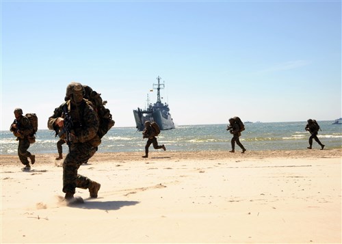 PALANGA, Lithuania – U.S. Marine Sgt. Christopher Judy, second from left, leads U.S. Marines onto a beach during a Baltic Operations (BALTOPS) 2012 amphibious operation exercise, June 11. This is the 40th iteration of BALTOPS, a maritime exercise intended to improve interoperability with partner nations by conducting realistic training at sea. 