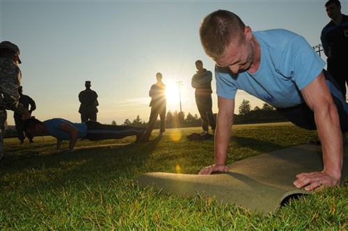 German Soldiers complete the push-up portion of the Army Physical Fitness Test July 27, as they prepare to take part in the 2011 Expert Field Medical
Badge standardization and testing at Grafenwoehr, Germany. The NATO troops will be joined later this week by nearly 300 U.S. Army and Navy medical
personnel, who will vie for the coveted badge from July 31 - August 13. (U.S. Army photo by Sgt. 1st Class Christopher Fincham)